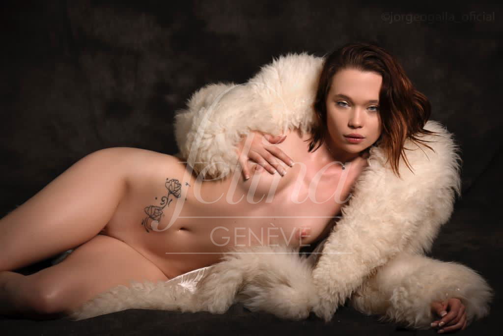 Young escort Sophie covered by feather coat at Felina Geneva